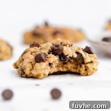 Chocolate chip zucchini cookie with a bite taken out of it.