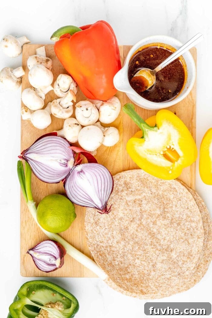 An overhead shot showcasing a colorful array of fresh vegetables meticulously arranged on a cutting board, alongside a small bowl of savory marinade and a soft wheat tortilla.