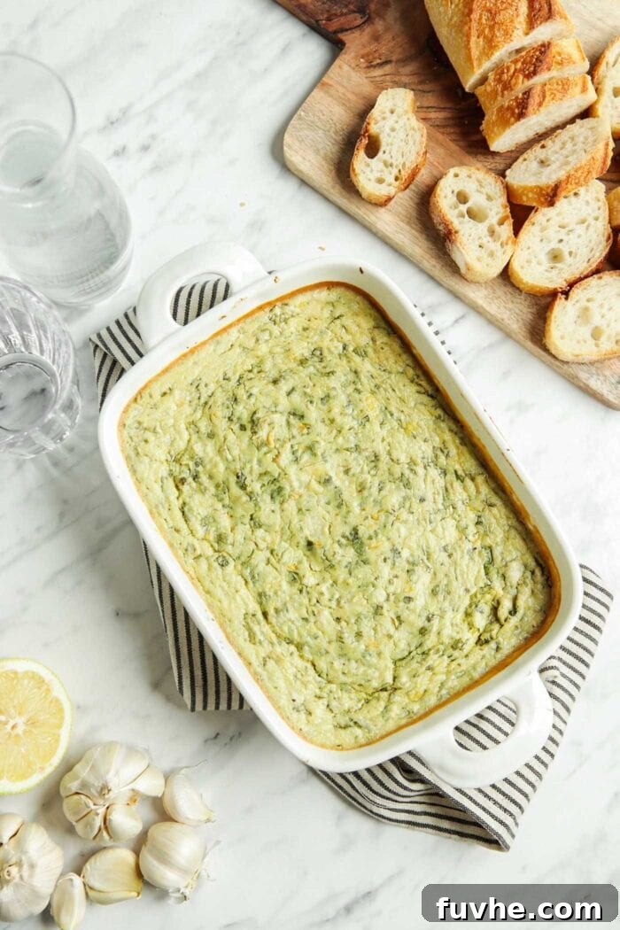 Velvety Vegan Spinach Artichoke Dip 7 Cooked spinach artichoke dip in a baking dish.