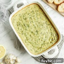 Velvety Vegan Spinach Artichoke Dip 9 Cooked spinach artichoke dip in a baking dish.
