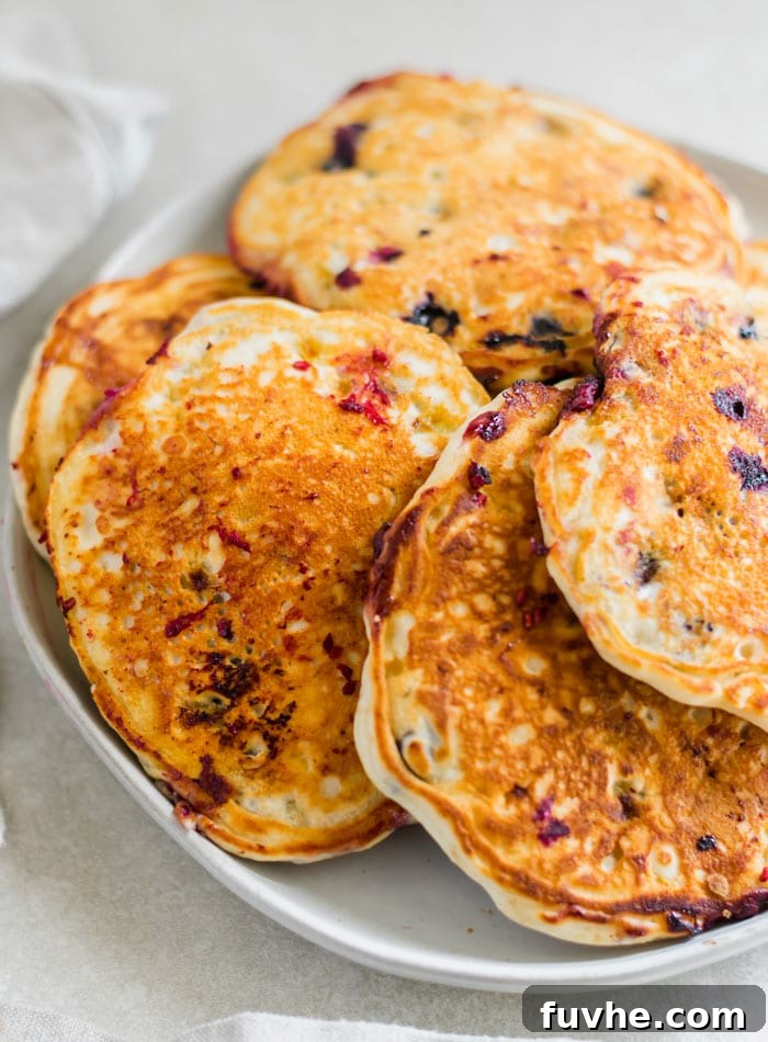 Flipping a Golden Brown Vegan Banana Pancake on a Griddle