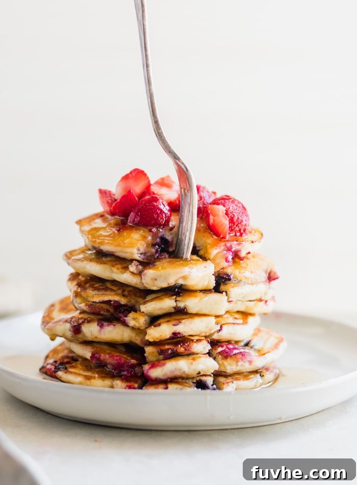 Beautifully Stacked Healthy Vegan Banana Pancakes with Berries and Syrup