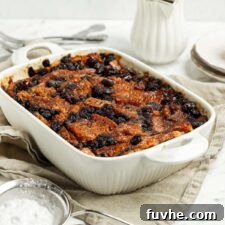 Baked vegan bread pudding in a baking dish, beautifully golden brown.
