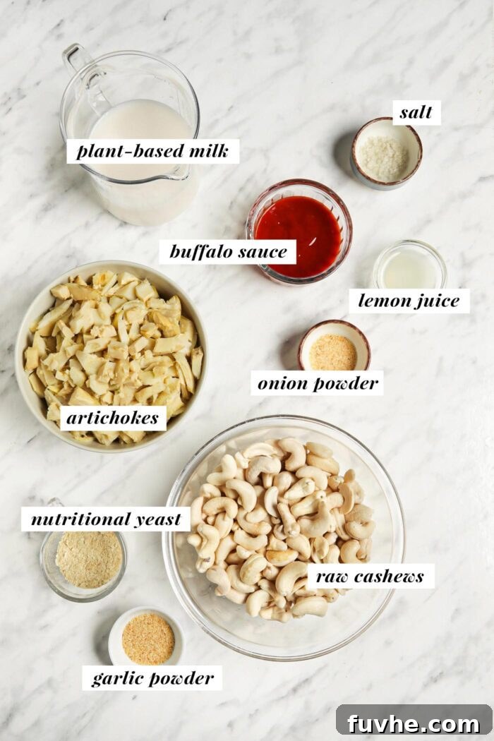 Visual list of labeled ingredients for making a vegan buffalo chicken dip recipe, including cashews, artichoke hearts, plant-based milk, and buffalo sauce.
