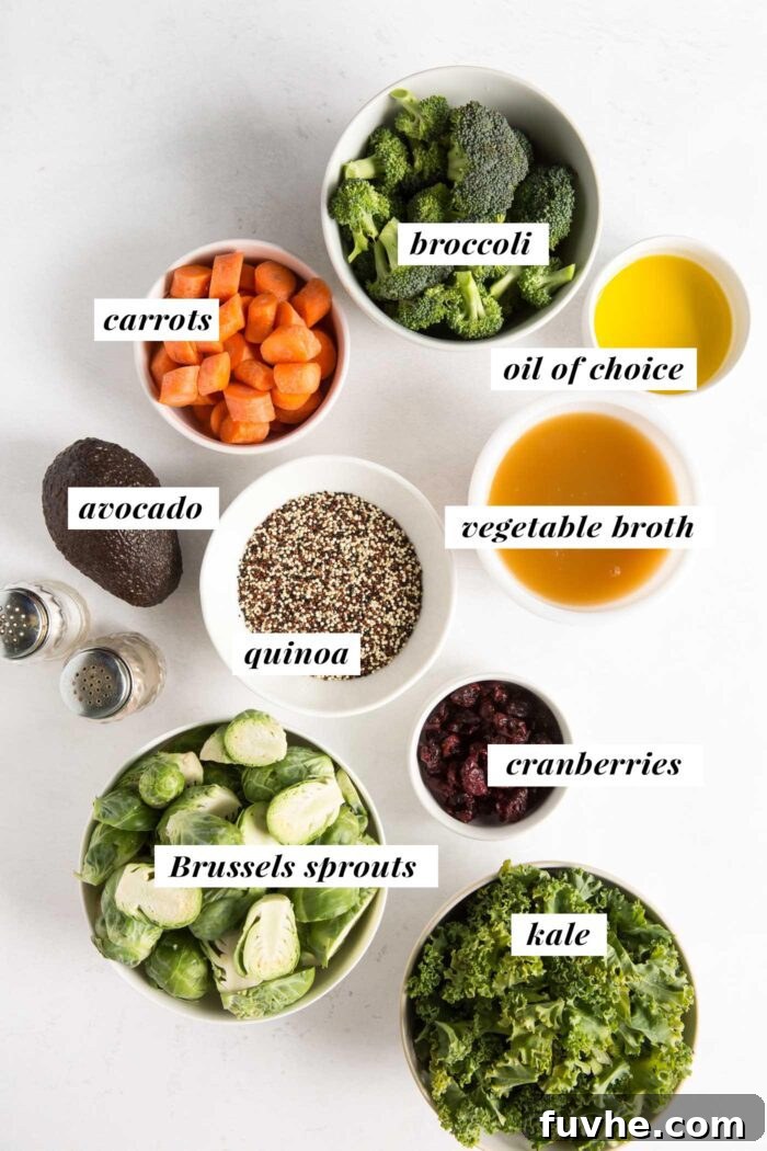 A visual display of fresh ingredients laid out, including vibrant kale, crisp Brussels sprouts, bright carrots, and florets of broccoli, ready for a healthy quinoa salad.