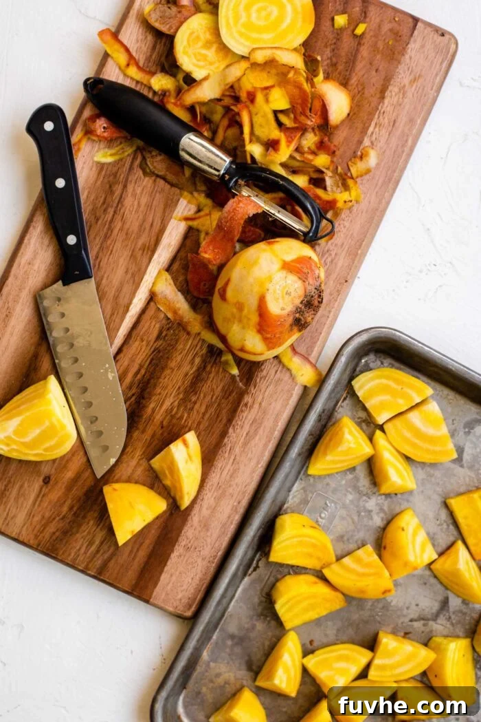 Large peeled golden beets on a cutting board with a knife and peeler, demonstrating preparation.