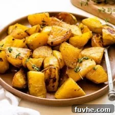Plate of roasted golden beets with fresh thyme.