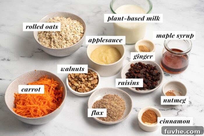 A visual display of all the simple, wholesome ingredients required to prepare a vegan carrot cake baked oatmeal recipe, including applesauce, maple syrup, ground flaxseed, raisins, and walnuts, arranged neatly.