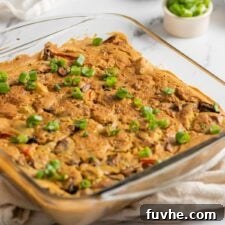 A golden-brown baked vegan potato egg casserole in a glass baking dish, invitingly ready to be served.