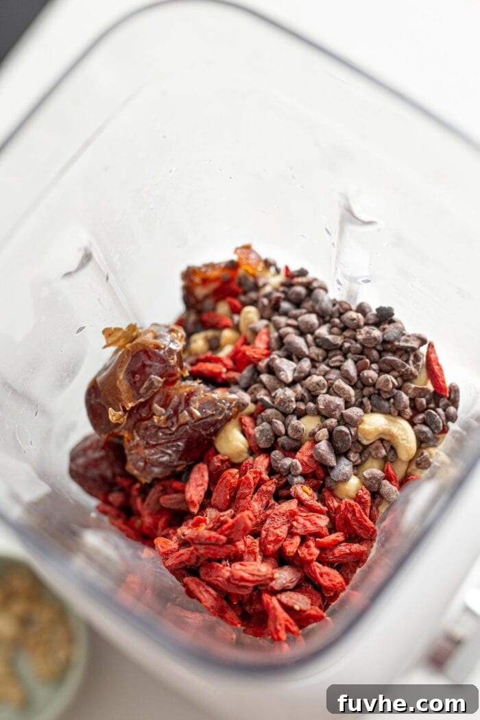 Goji berries, dates, cashews and cacao nibs in a blender.