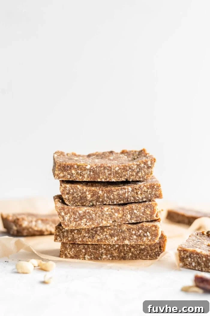 Fuel Your Journey: 14 Vegan Road Trip Snacks 3 Stack of 5 vegan paleo energy bars sitting on parchment paper against a white background.