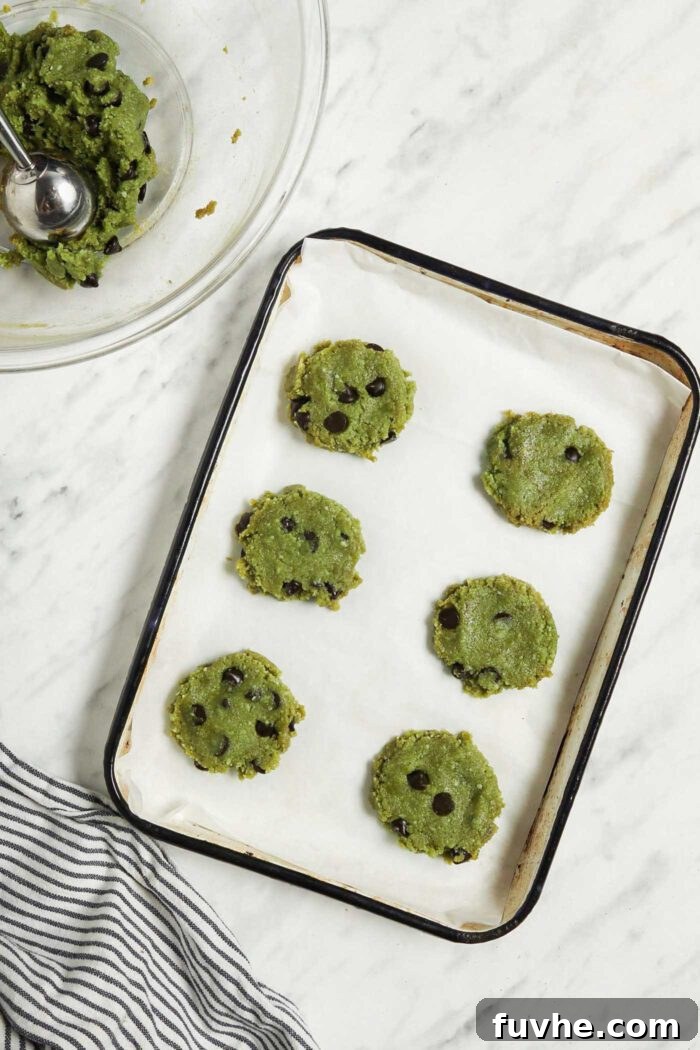 Sublime Vegan Matcha Cookies 5 6 raw matcha cookies on a small baking tray.