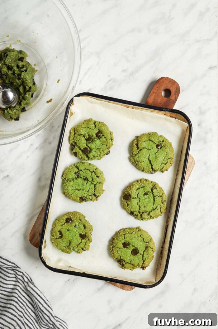 Sublime Vegan Matcha Cookies 6 6 green vegan matcha cookies on a baking tray.
