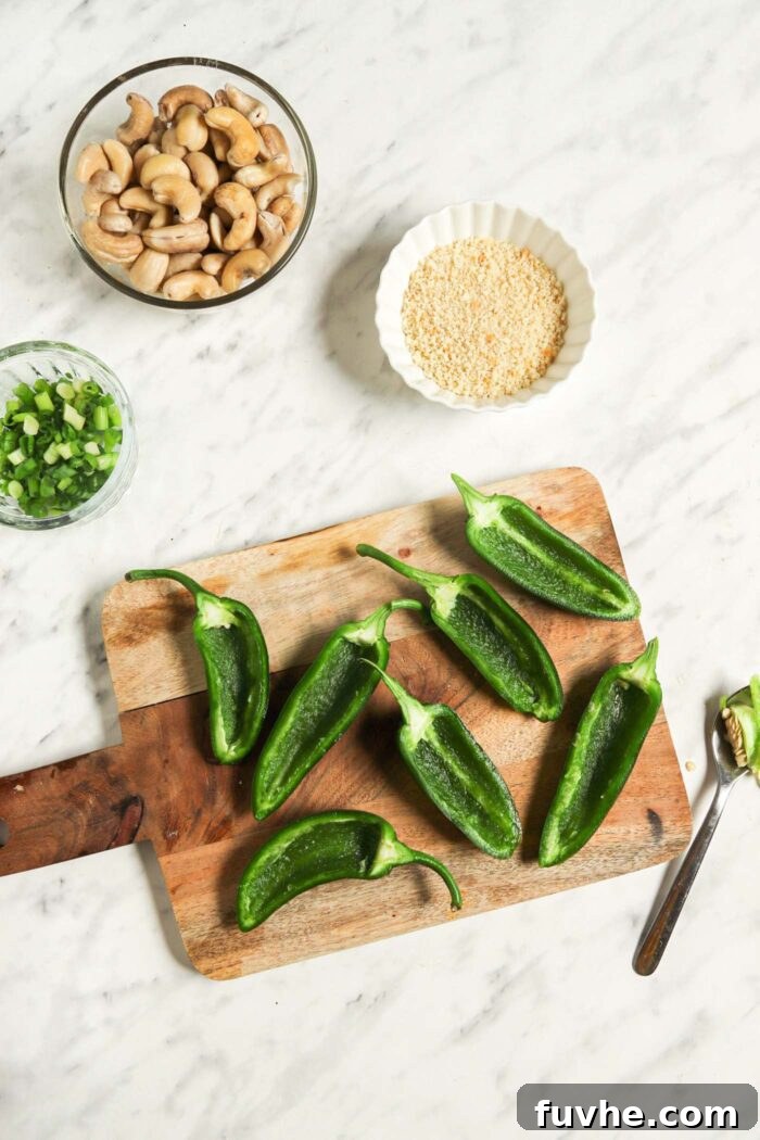 Creamy Vegan Jalapeño Bites 4 Freshly sliced jalapeños with all seeds and white membranes removed, neatly arranged on a cutting board, ready for filling.
