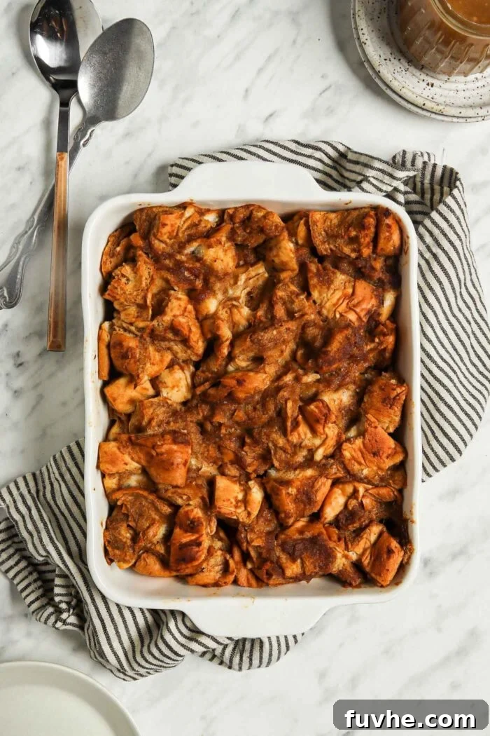 Vegan french toast casserole in a rectangular casserole dish sitting on a dish towel.