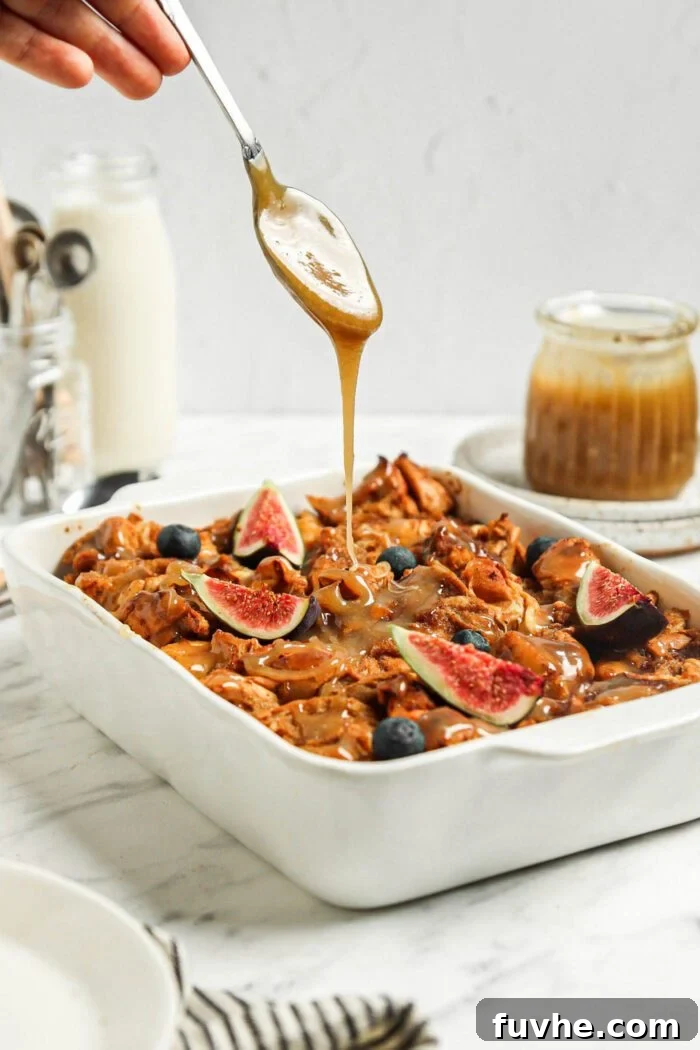 Drizzling caramel sauce over a casserole dish of baked vegan French toast.