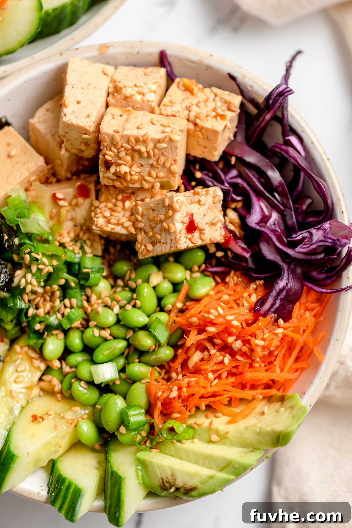 Vegan poke bowl with veggies, edamame and tofu poke.