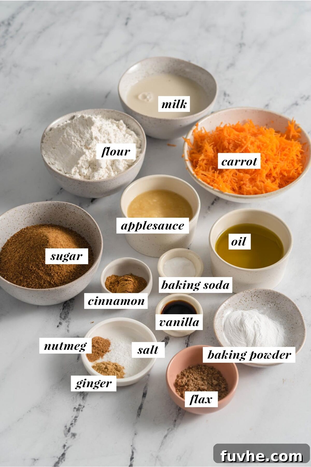 The Perfect Plant-Based Carrot Cake 3 A beautiful flat lay photograph showcasing all the fresh, dry, and liquid ingredients needed for making a healthy vegan carrot cake, with each ingredient clearly visible and ready for preparation.