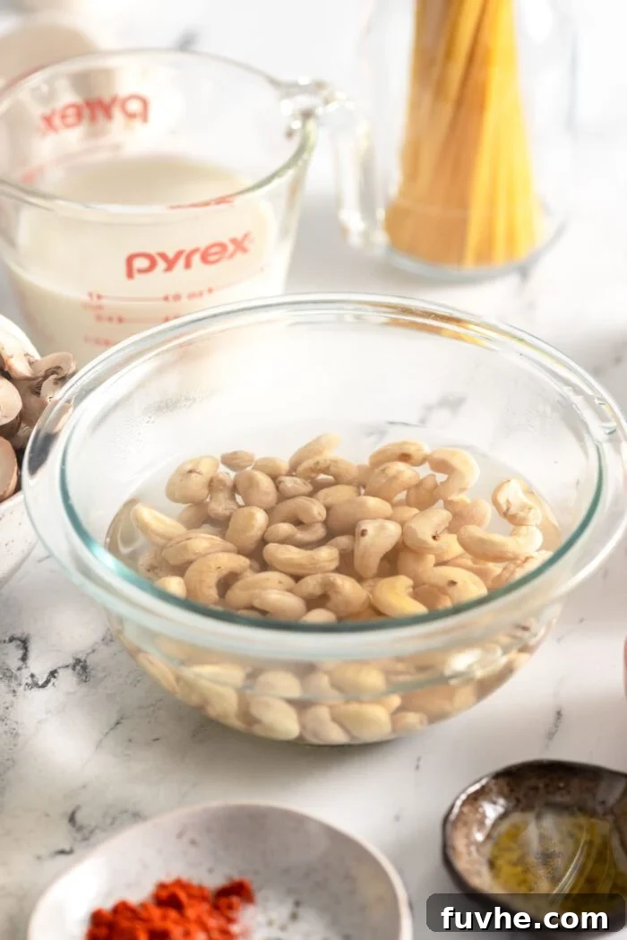 Plant-Based Carbonara 4 Cashews soaking in water in a glass bowl.