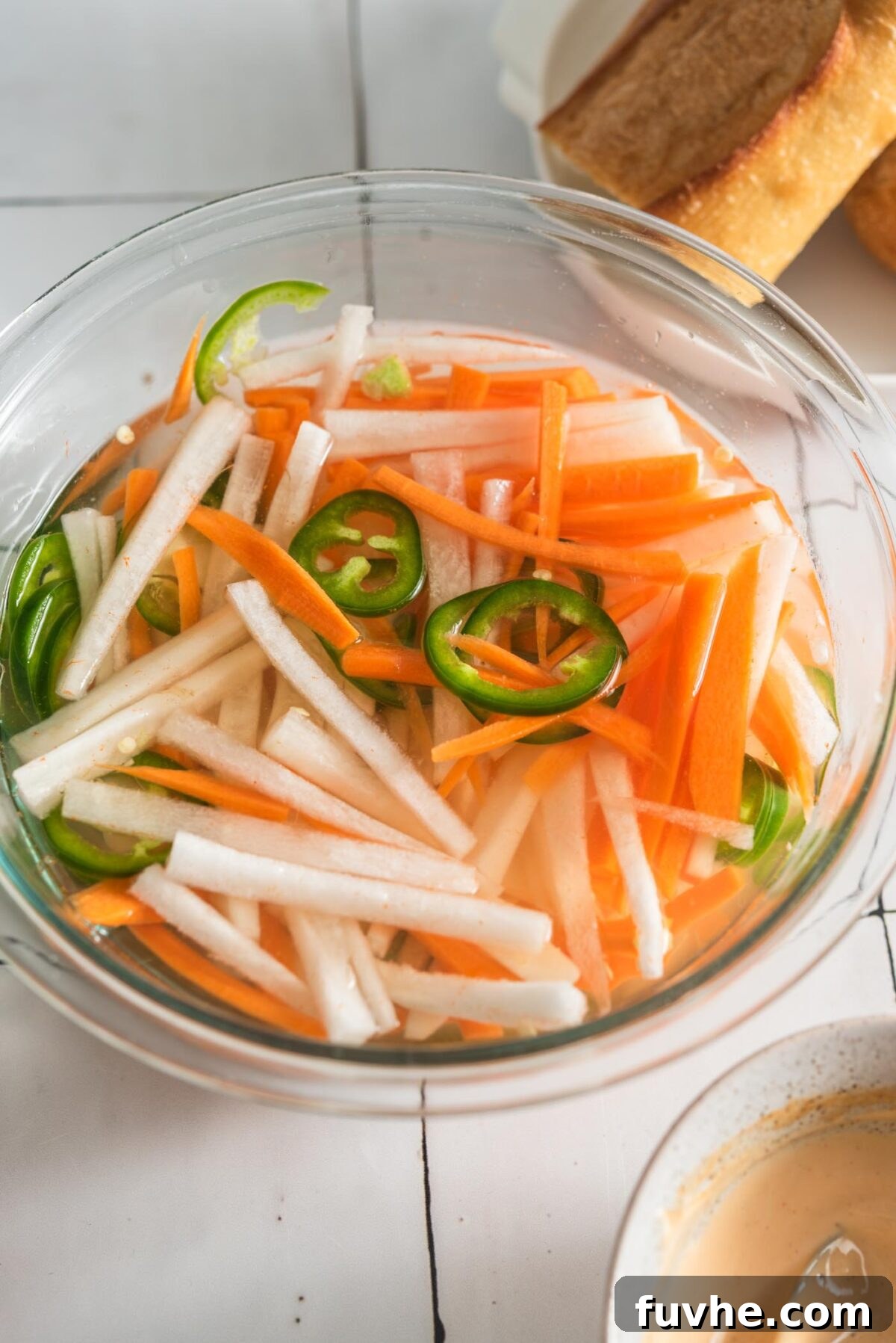 Ultimate Vegan Tofu Banh Mi 4 Pickled carrot, daikon and jalapeno in a glass bowl.