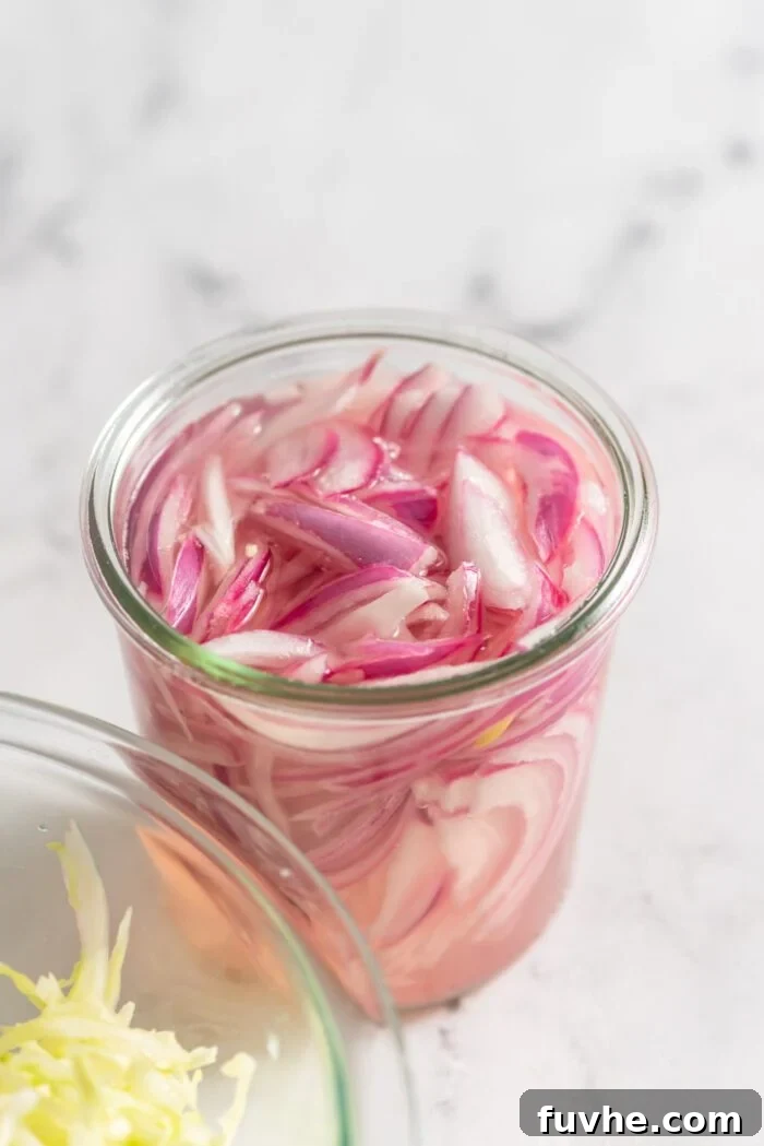 Ultimate Black Bean Tacos 3 A jar of thinly sliced pickled red onions.