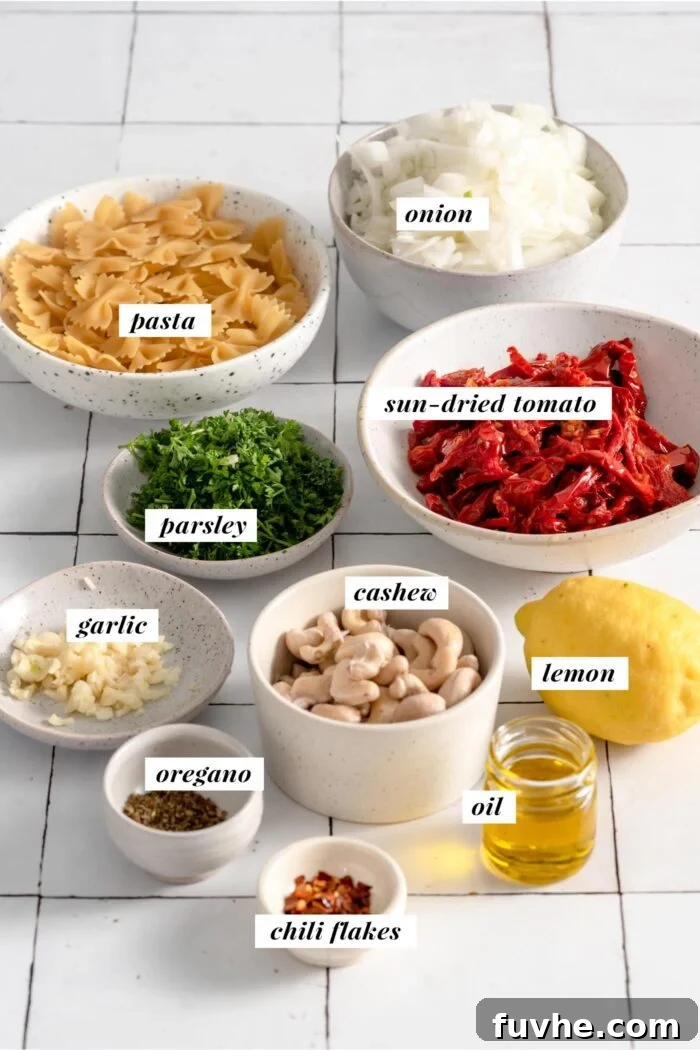 All the essential ingredients meticulously arranged for a vegan sun-dried tomato pasta recipe, clearly showing each item.