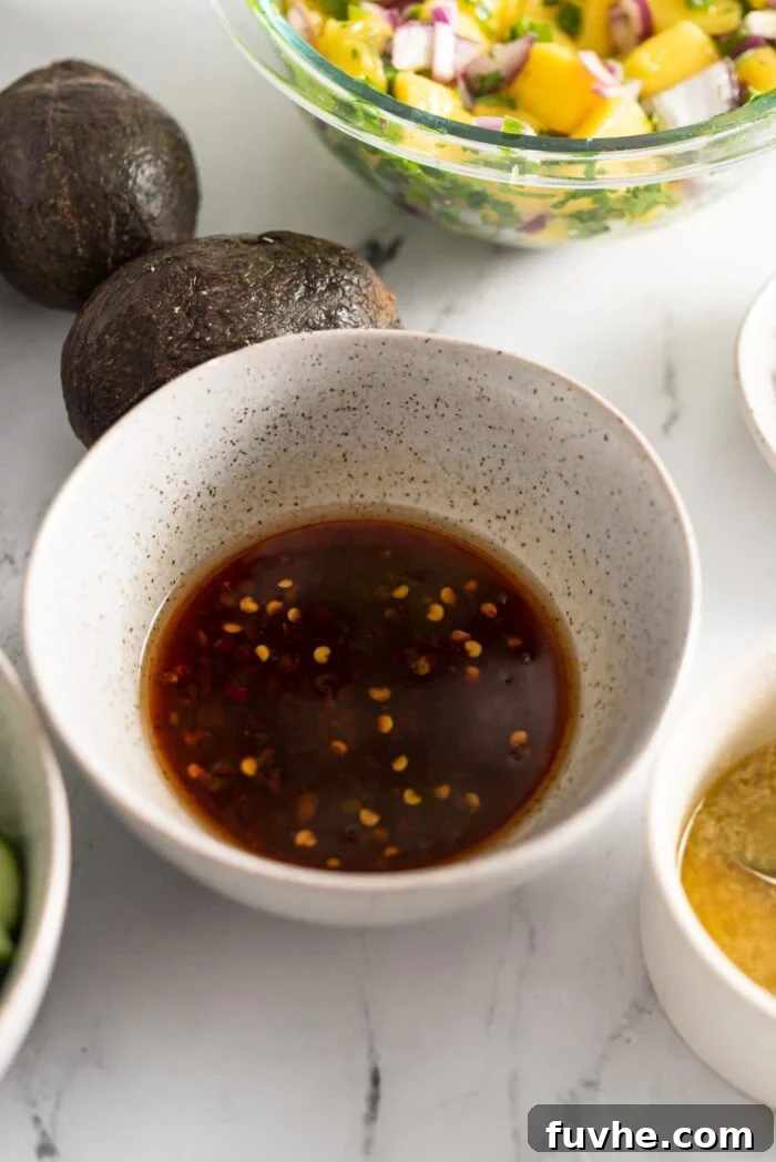 Dark soy chili sauce mixed together in a small bowl, showcasing its rich texture and color.