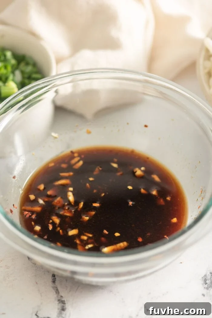 Flavorful Vegan Udon Noodle Stir Fry 4 Udon noodle stir fry sauce mixed in a small glass bowl, showing a dark, rich consistency.