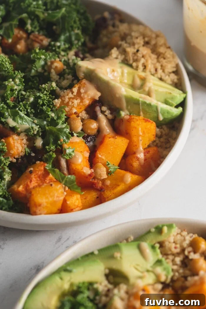 Vibrant Vegan Quinoa Fuel Bowls 9 A close-up shot of a healthy and colorful vegan quinoa power bowl, featuring roasted butternut squash, fluffy quinoa, creamy avocado, tart cranberries, and crunchy pecans.