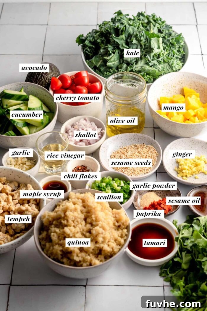 All of the ingredients for making a quinoa grain bowl recipe gathered in bowls. Each ingredient is labelled with text.