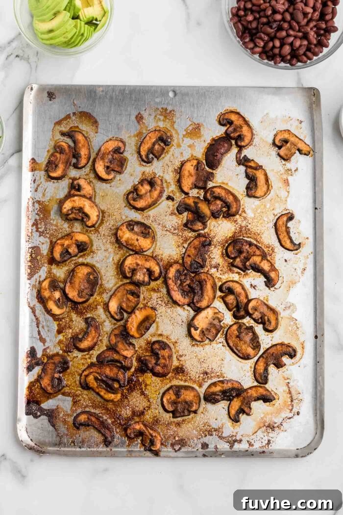 Zesty Plant-Powered Fajita Bowls 8 Marinated sliced and roasted mushrooms on a baking tray.