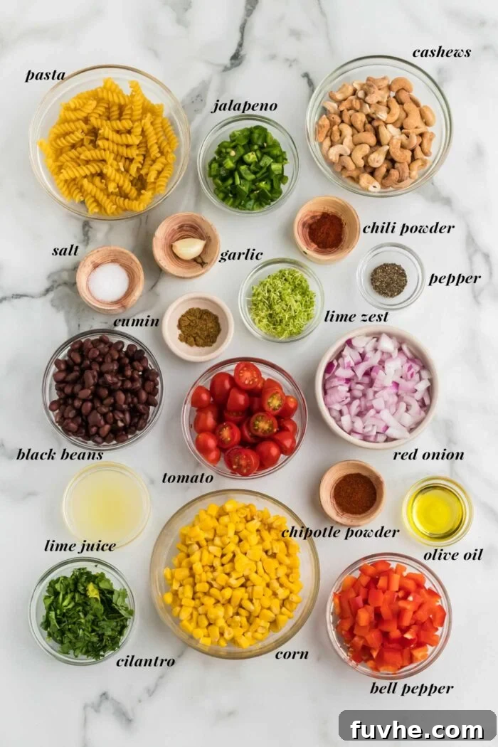 Chipotle Lime Vegan Pasta Salad 3 All the ingredients gathered for making a vegan southwest pasta salad with bell pepper, red onion, jalapeno and cashew sauce. Each ingredient is labelled with text.