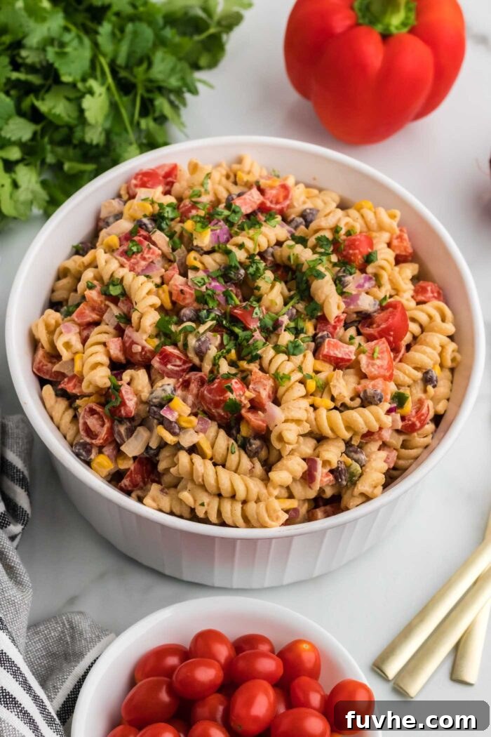 Chipotle Lime Vegan Pasta Salad 9 Overhead view of a large bowl of vegan southwest pasta salad with cilantro, black beans, corn, bell pepper and chipotle dressing..