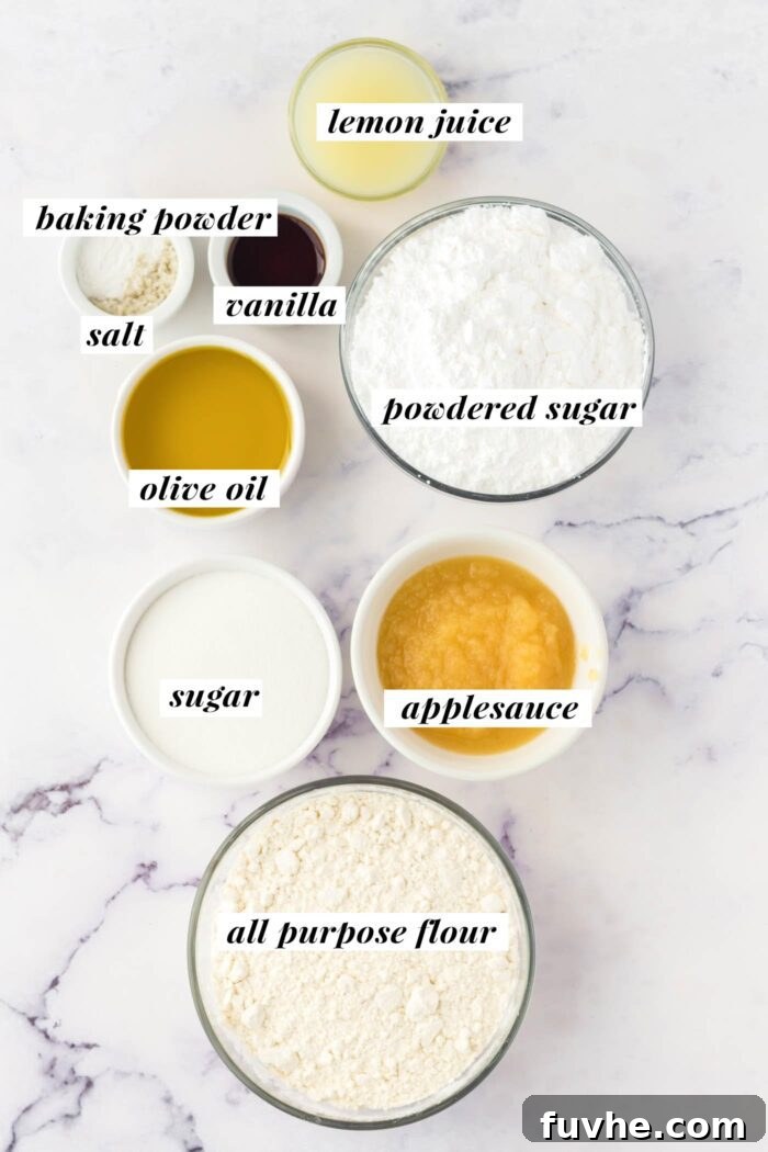 Various ingredients for a vegan olive oil cake recipe, neatly arranged in separate bowls and clearly labeled with text on a rustic wooden surface.