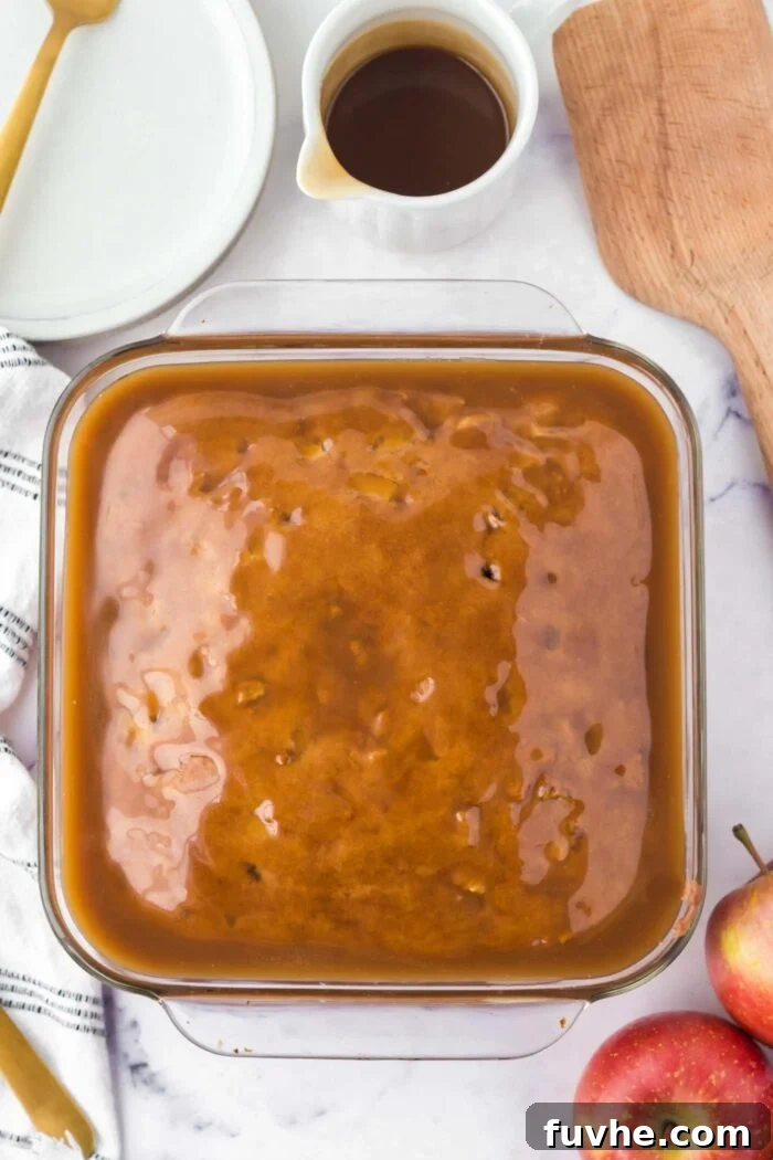 Overhead view of an apple cake covered in a layer of caramel glaze.