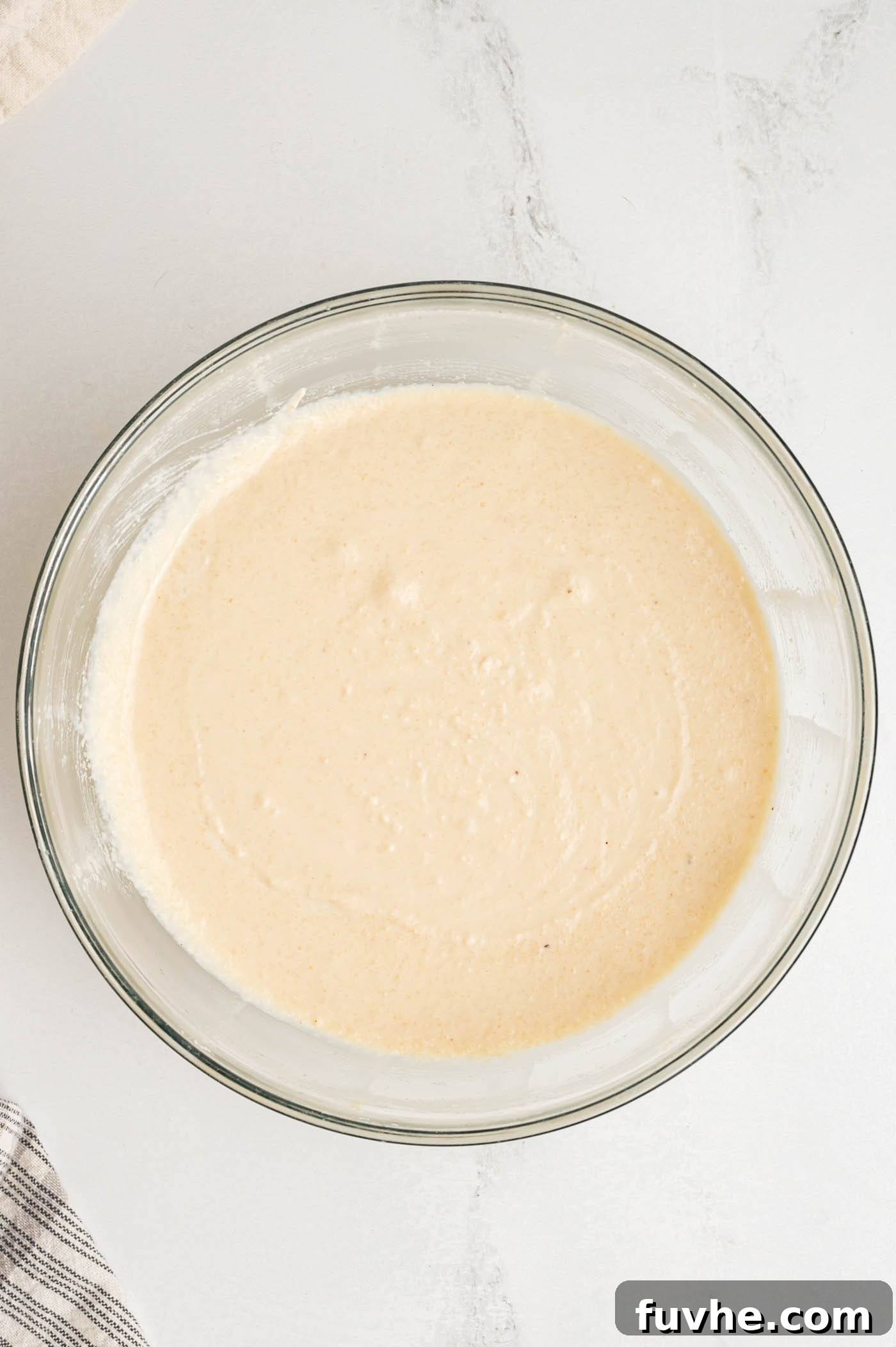 Decadent Vegan Tiramisu 14 A cream cheese-like beige cream in a glass mixing bowl.