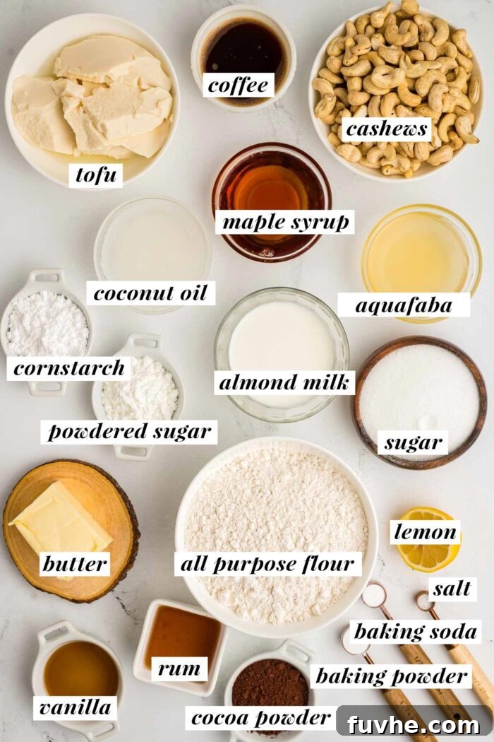 Decadent Vegan Tiramisu 3 All the ingredients for vegan tiramisu recipe gathered in bowls and containers. Each ingredient is labelled with text. Find the ingredient list in the recipe card on the corresponding blog page.