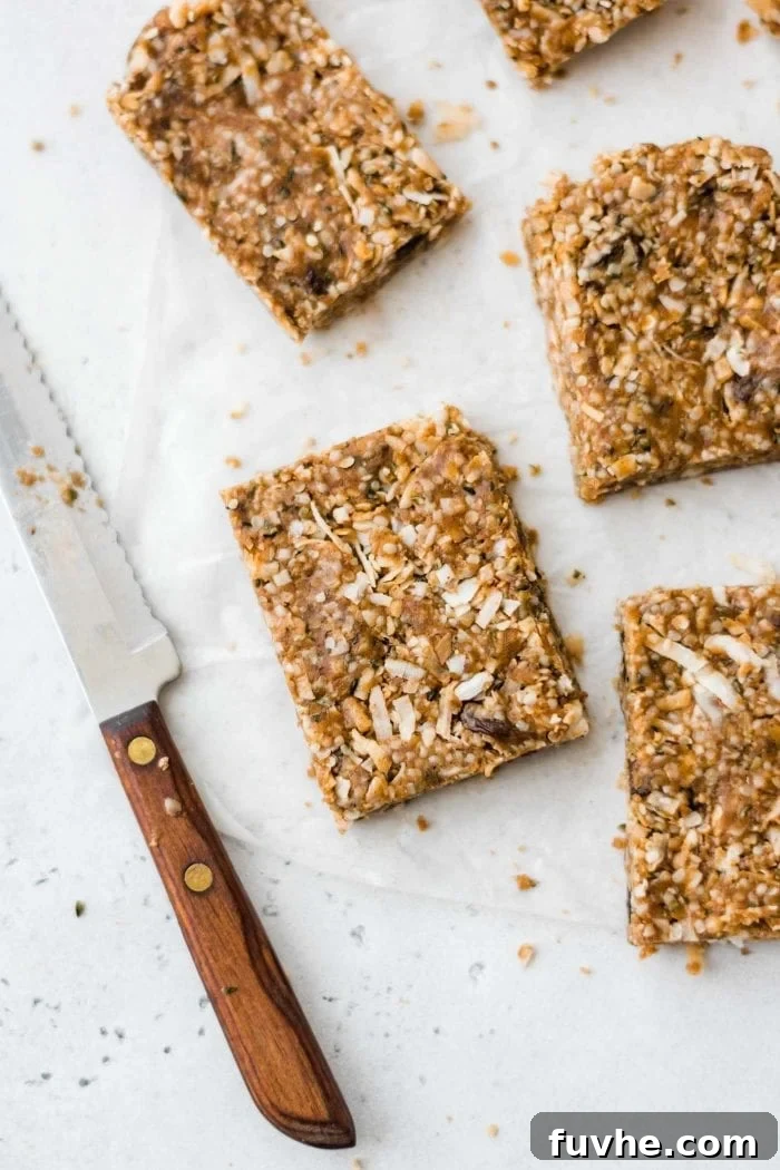 Freshly sliced paleo granola bars laid out on a piece of parchment paper, showcasing their texture.