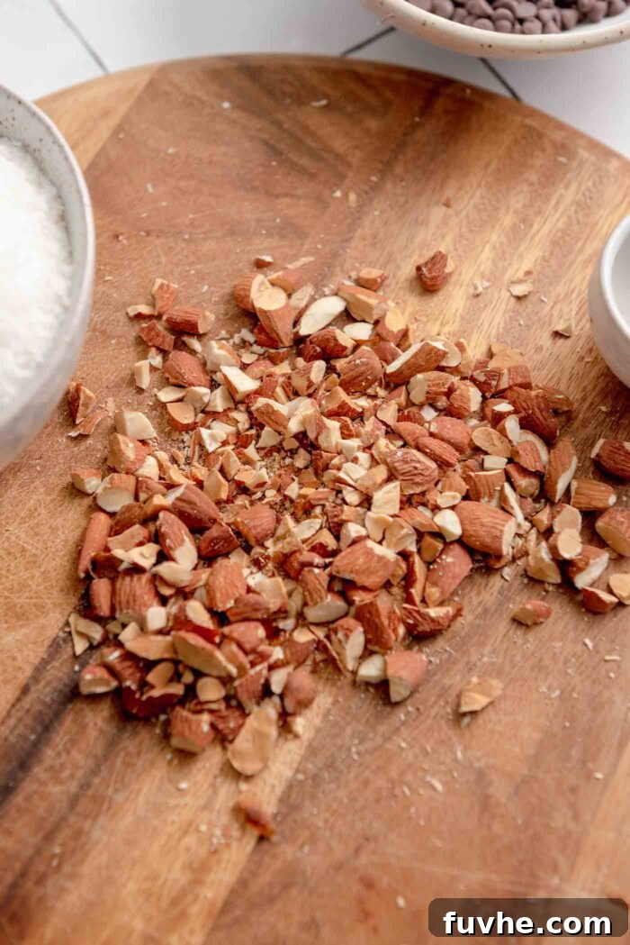 Plant-Powered Almond Coconut Dreams 4 Chopped almonds on a cutting board.