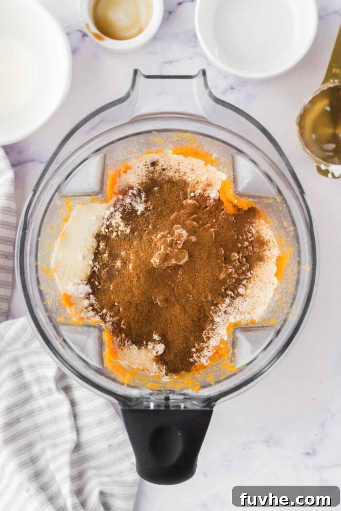 Coconut cream, spices and baked sweet potato in a Vitamix container.