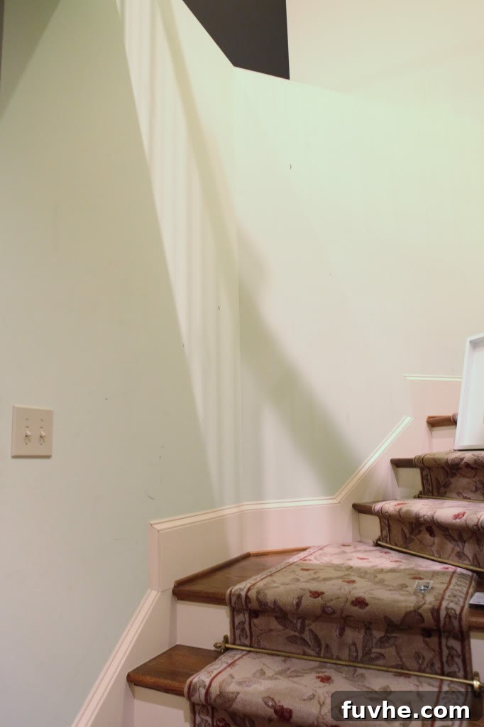 Collection of white picture frames in various sizes for a stairway gallery wall project