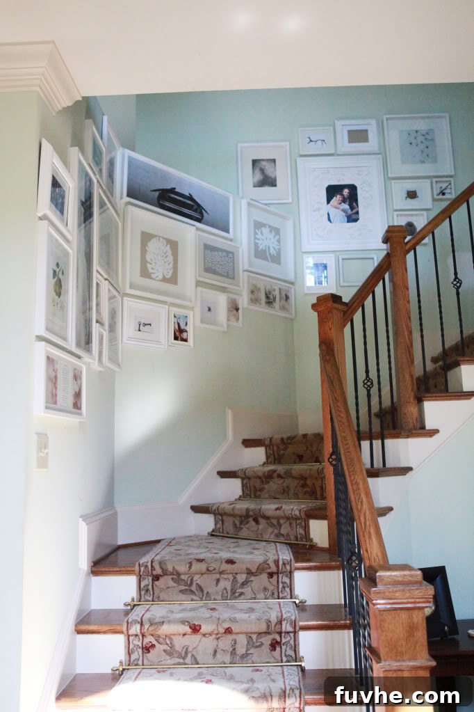Stairway gallery wall with placeholder art in white frames, ready for personalization