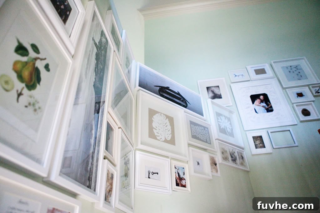 Completed stairway gallery wall on transformed half wall, showcasing final look