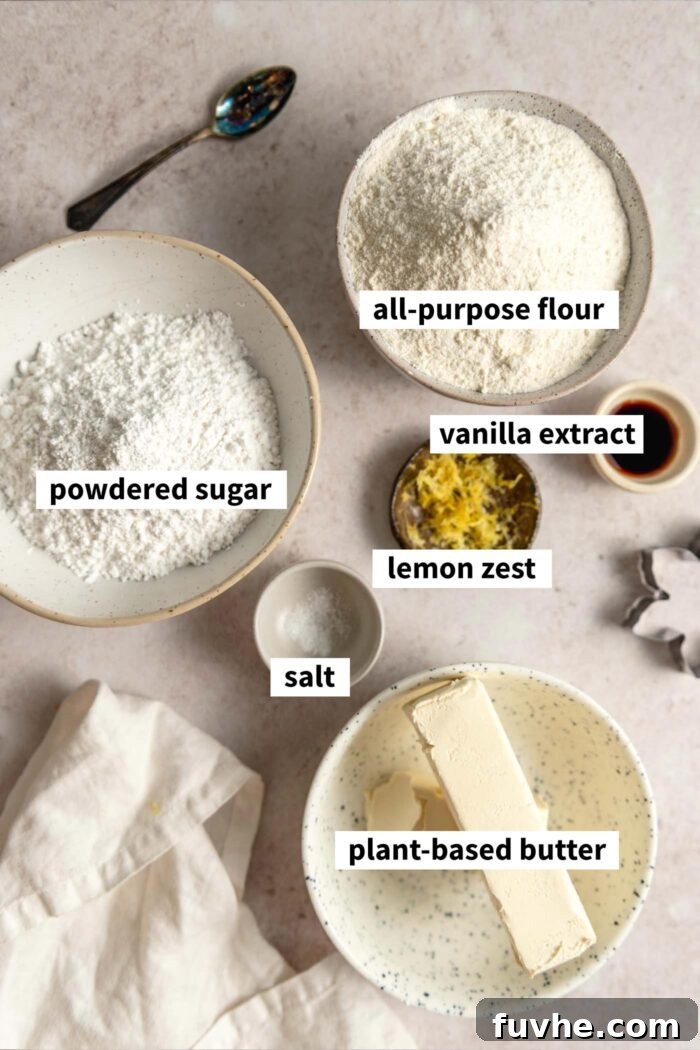 Zesty Lemon Shortbread Bites 3 The ingredients needed for making a lemon shortbread cookie recipe. Each ingredient is labelled with text overlay.