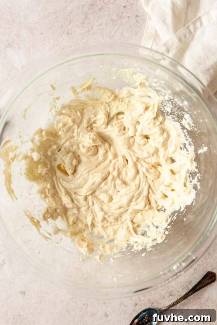 Zesty Lemon Shortbread Bites 4 Butter and sugar whipped into a light and fluffy mixture in a glass mixing bowl.