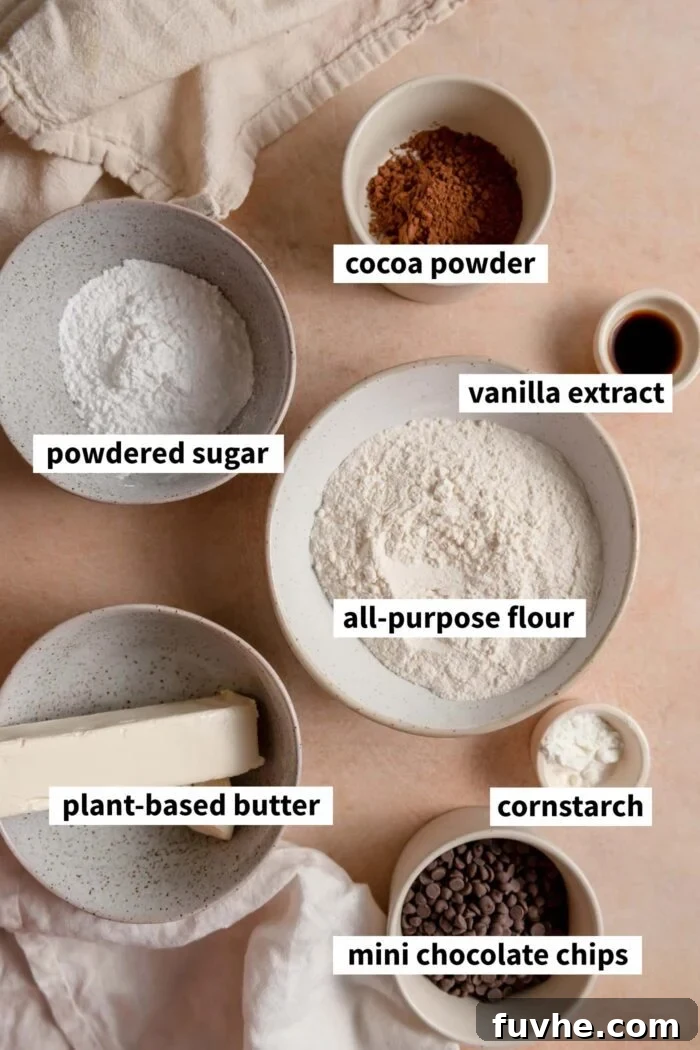 The ingredients needed for making a chocolate snowball cookie recipe. Each ingredient is labelled with text overlay.