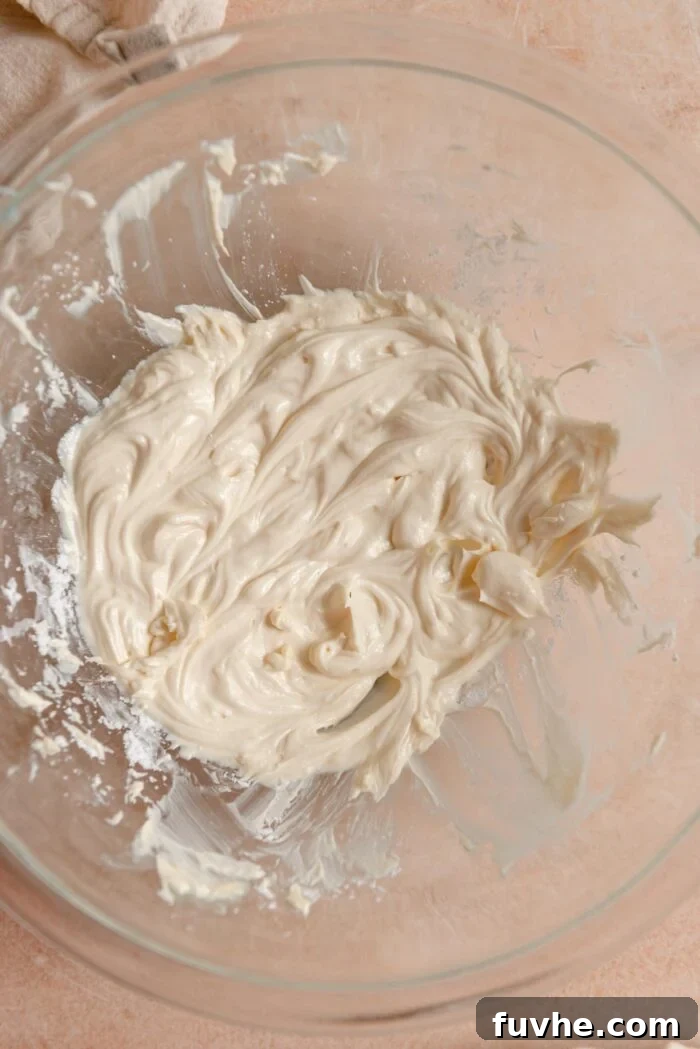 Butter and icing sugar beat together into a light and fluffy consistency in a mixing bowl.