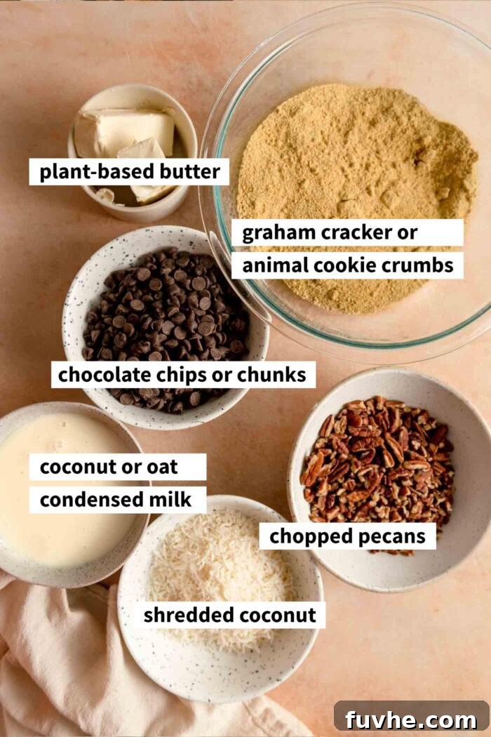 Bowls of all the key ingredients for making vegan 7 layer cookies bars, including graham cracker crumbs, vegan butter, pecans, shredded coconut, chocolate chips, and coconut condensed milk, ready for preparation.