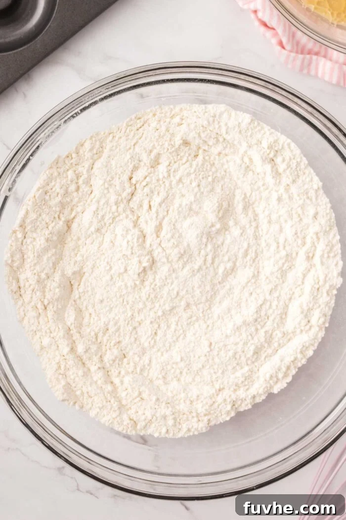 All-purpose flour in a large glass mixing bowl.