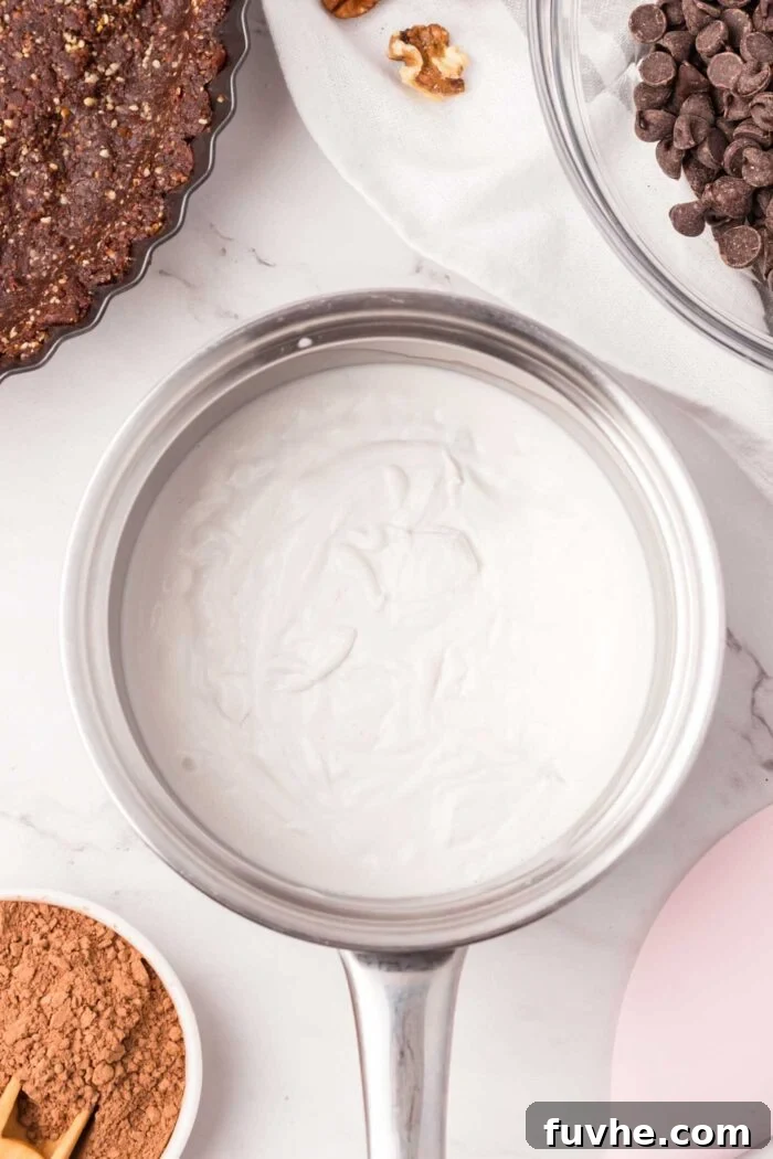 Thick coconut milk in a sauce pan.